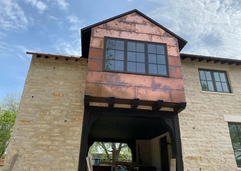 Copper metal panel facade on a stone building for Metal Roof Coating in Hurricane