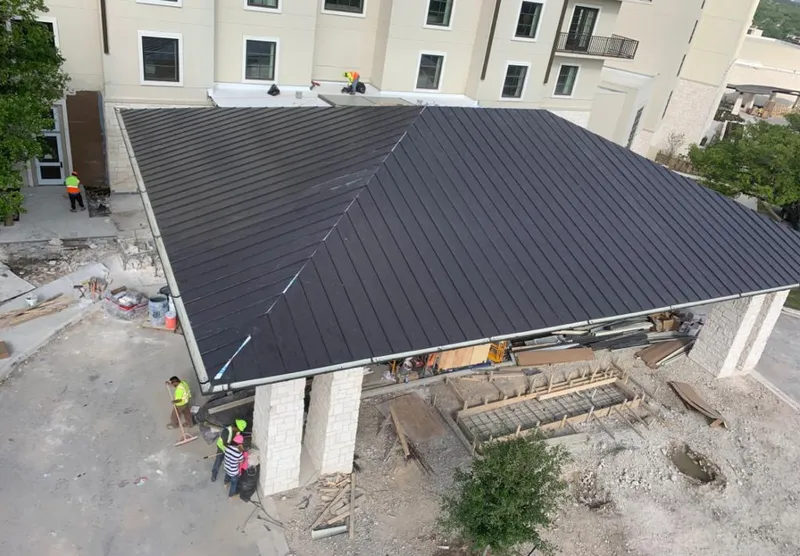 Metal roofing installation team working on a commercial building in Hurricane